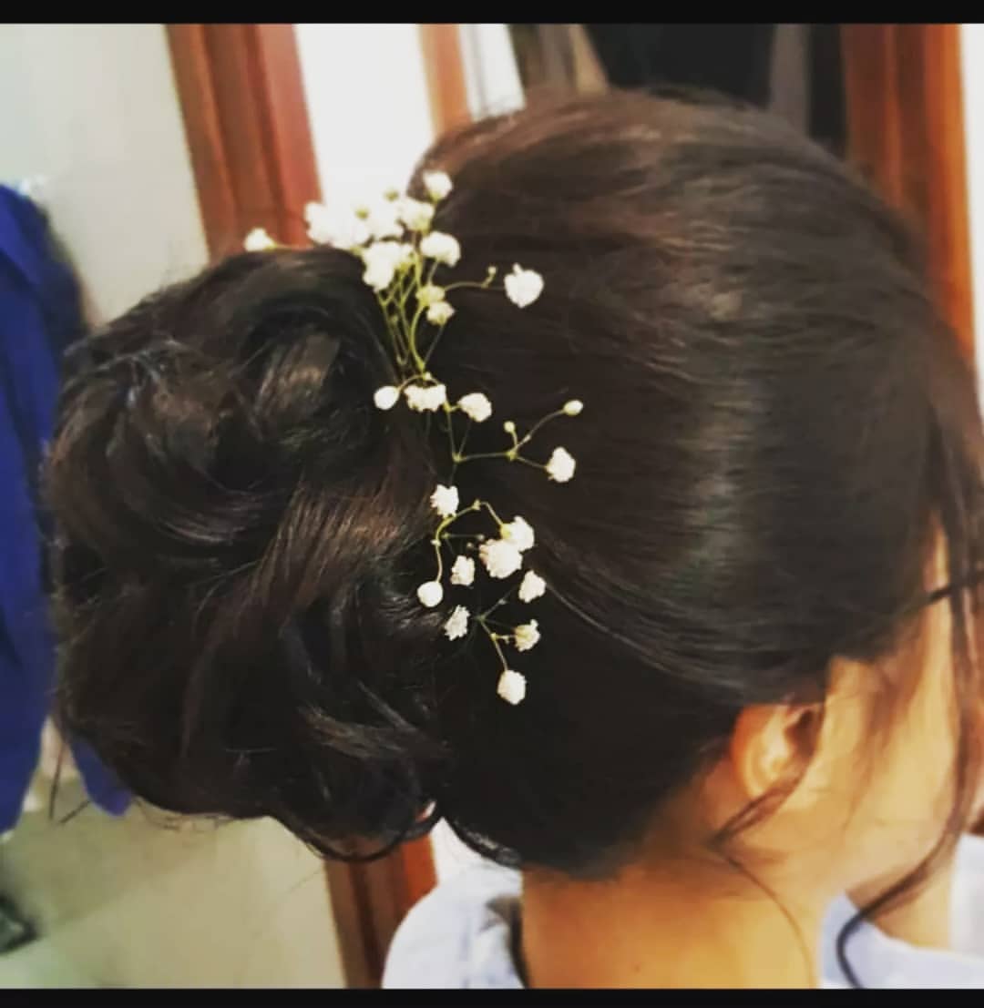 Modern half-up bridal hair design by hairstylisthyderabad